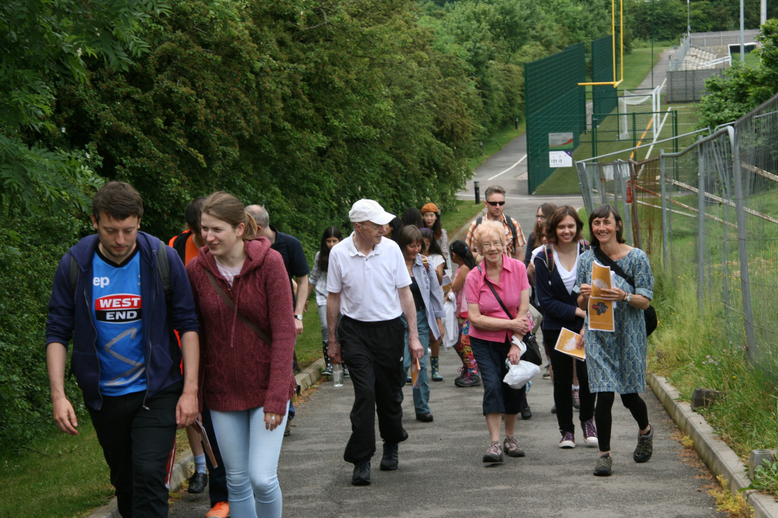 A group of people walking around the Fruit Routes route.