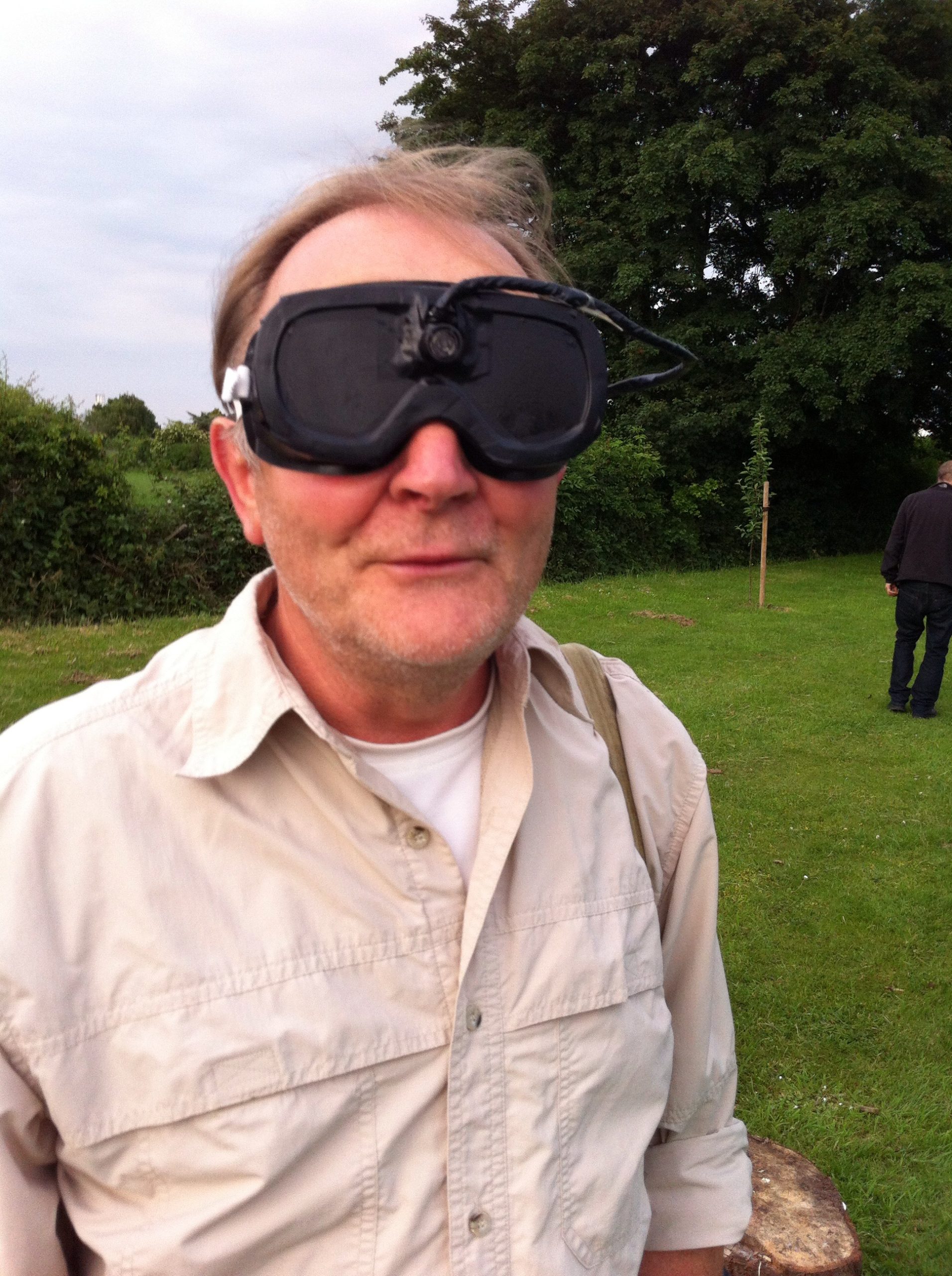 A man wearing blacked-out goggles
